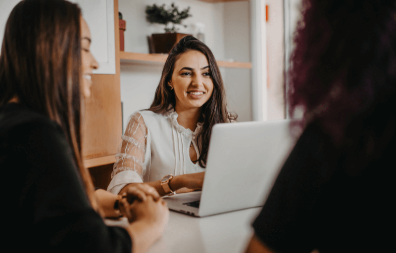3 women at a desk with a laptop (1)