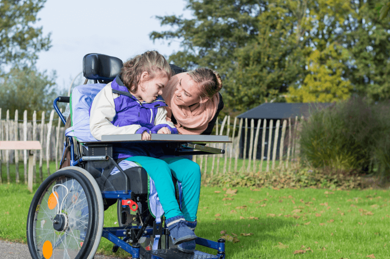Girl in a wheelchair with carer (1)