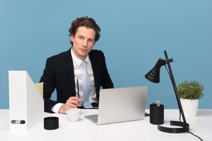 Man at a desk wearing a suit