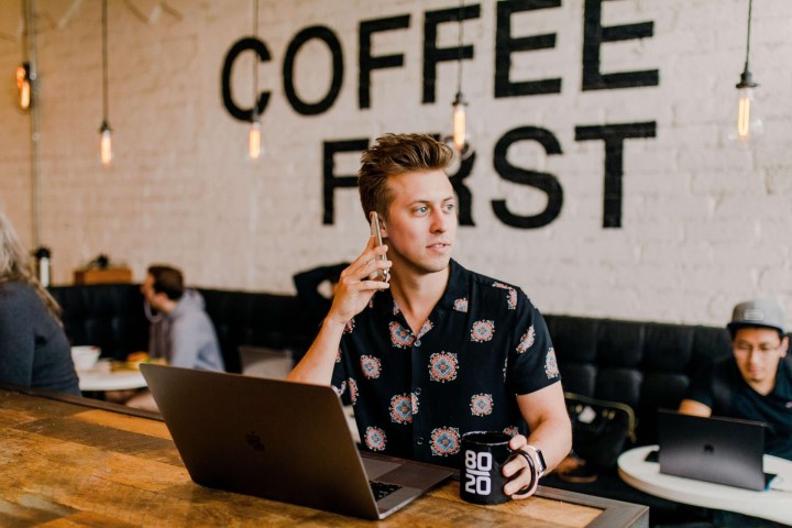 Man in a coffee shop using his mobile phone