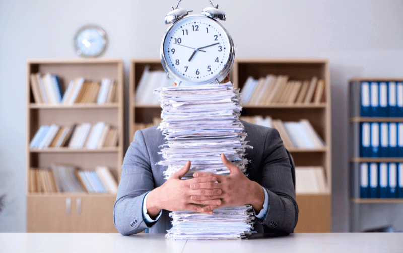 Man with stacks of paper (1)