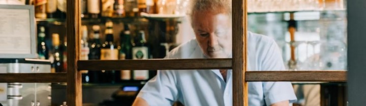 Older man working in a bar