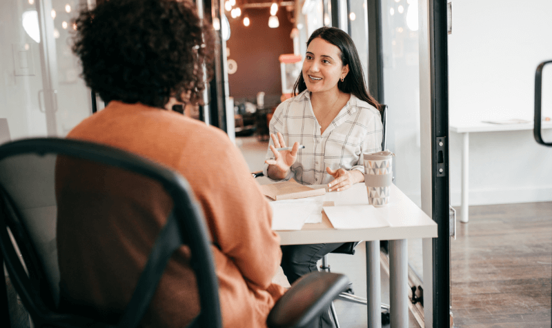 Person interviewing a woman (1)