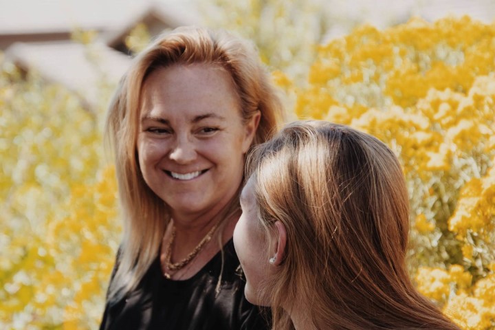 Two women talking in a meadow